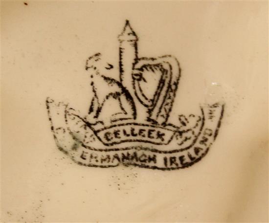 A Belleek bird and nest on a stump vase, late 19th century, 32cm, loss to bird